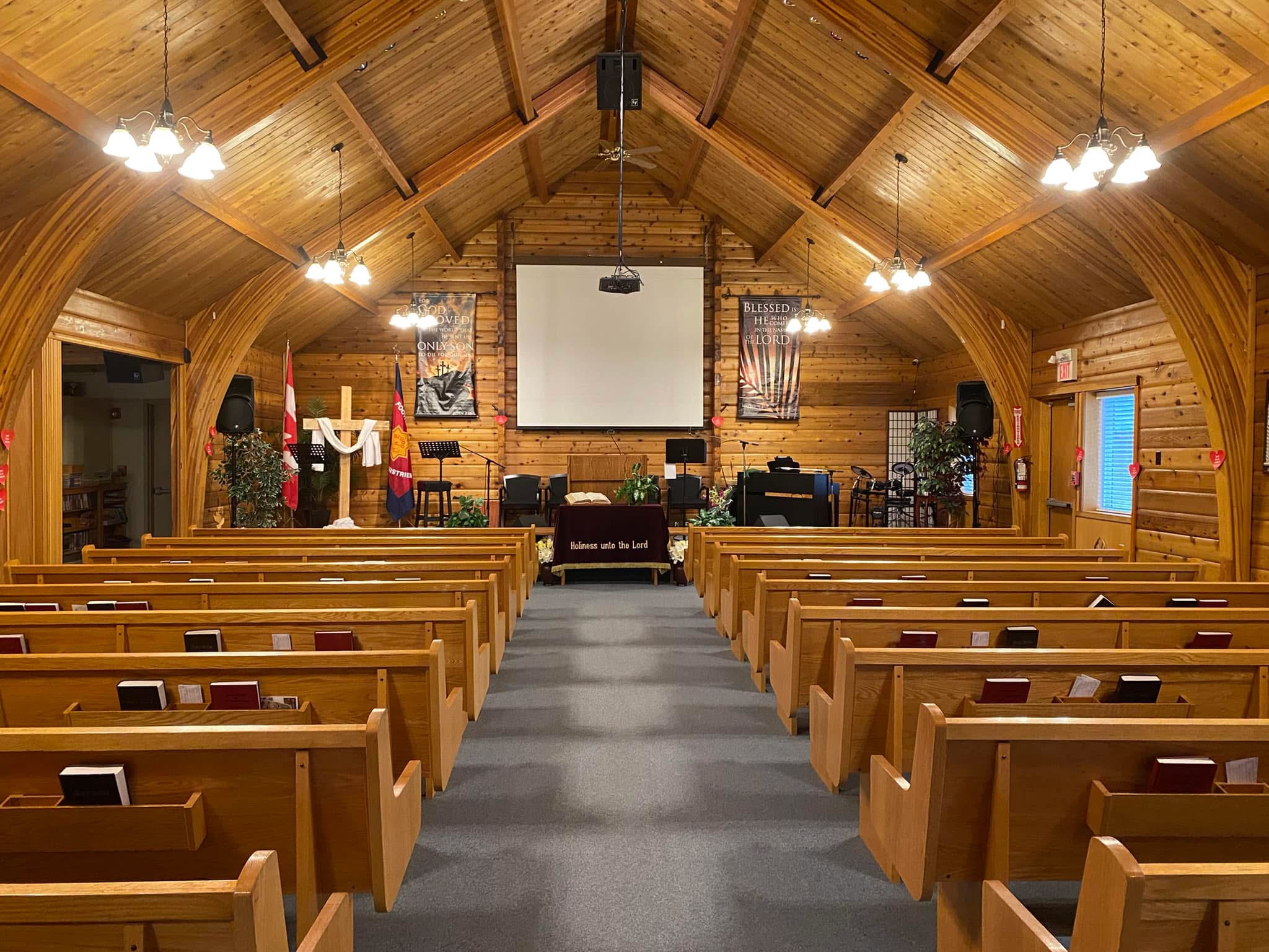 View from the back of the church showing rows of empty pews.